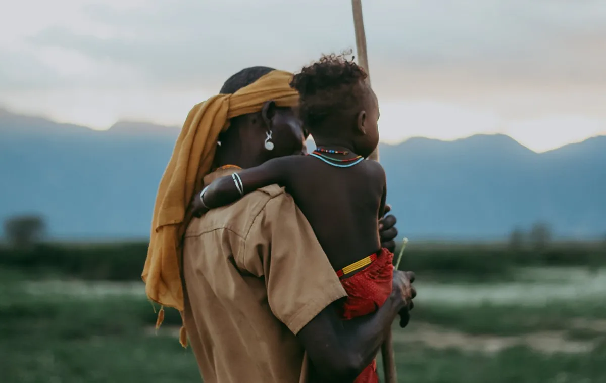 An Arbore parent carrying a child in Ethiopia